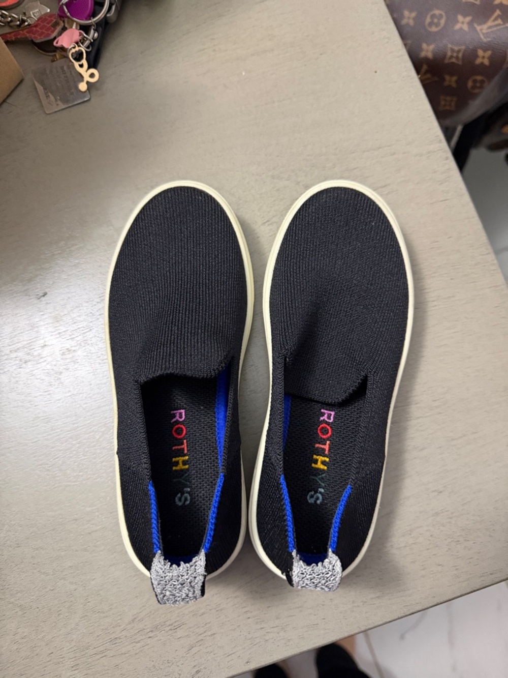 Kids Rothy's Black Slip-On Knit Sneakers with Cream Sole and Blue Accent